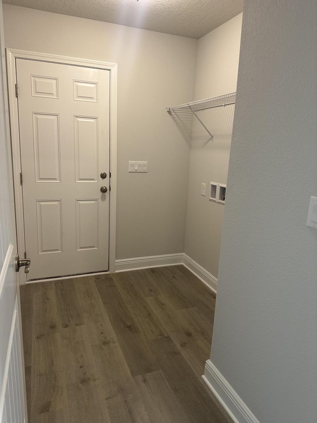 washroom featuring laundry area, baseboards, dark wood-style flooring, hookup for a washing machine, and a textured ceiling