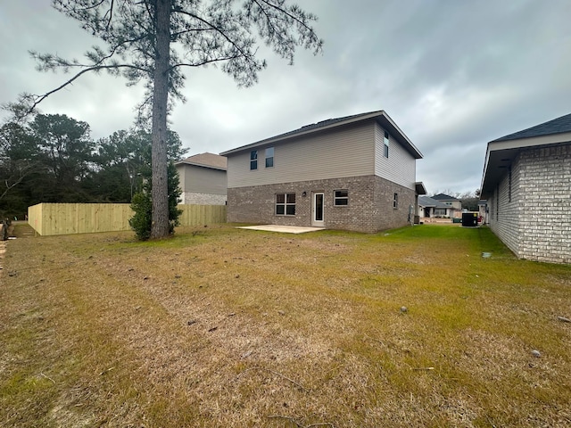 rear view of house featuring a lawn