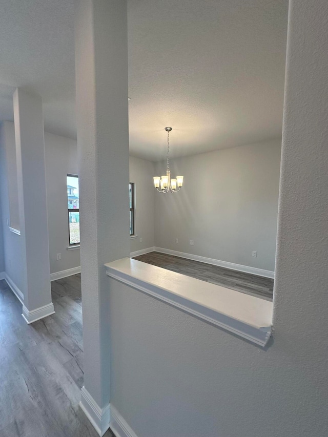 interior space featuring hardwood / wood-style floors and an inviting chandelier