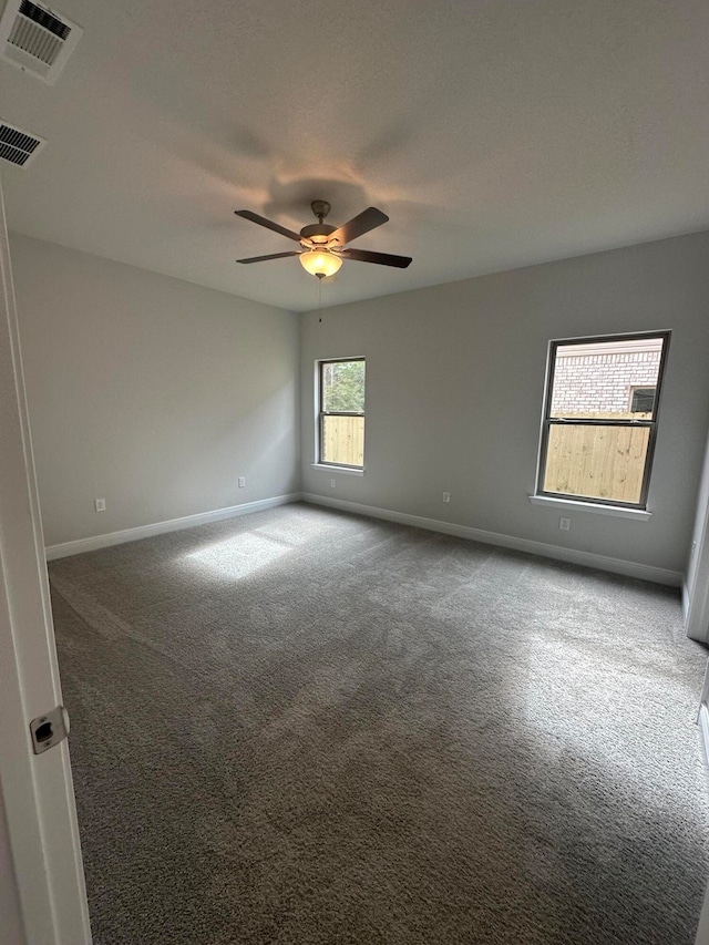 spare room featuring carpet floors and ceiling fan