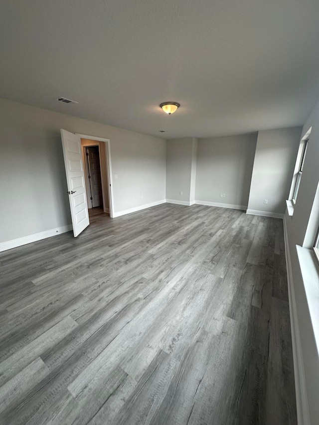 spare room featuring wood-type flooring