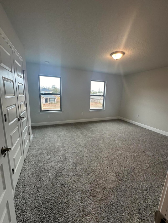 unfurnished room featuring carpet flooring