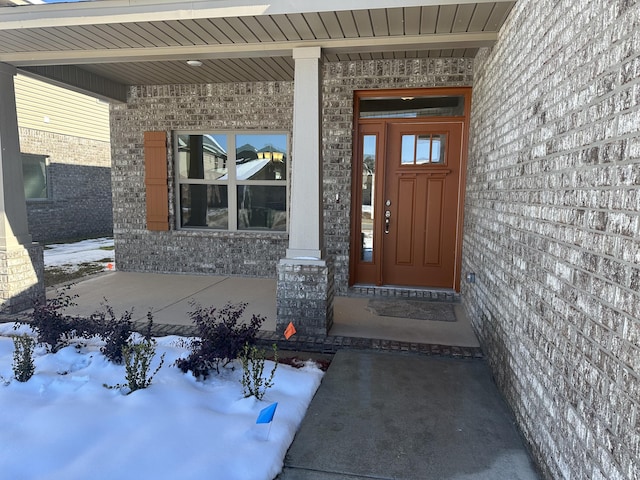 view of snow covered property entrance