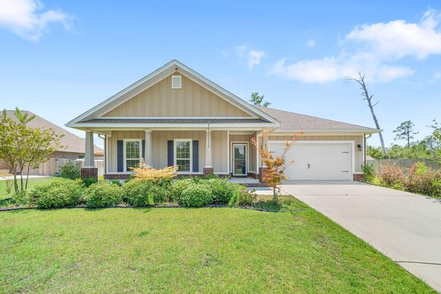 craftsman-style house with a garage, a front lawn, and covered porch