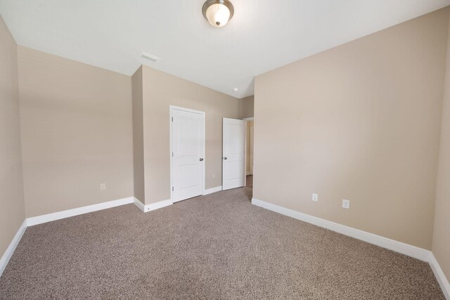 unfurnished bedroom featuring light carpet