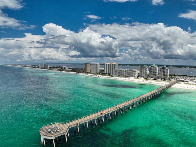 drone / aerial view featuring a beach view and a water view