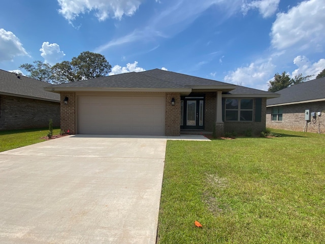 view of front of home with a garage and a front yard