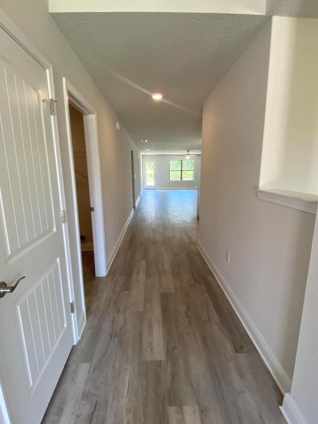 hallway featuring a textured ceiling and hardwood / wood-style floors