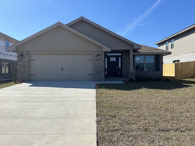 ranch-style home with concrete driveway, an attached garage, fence, a front lawn, and brick siding