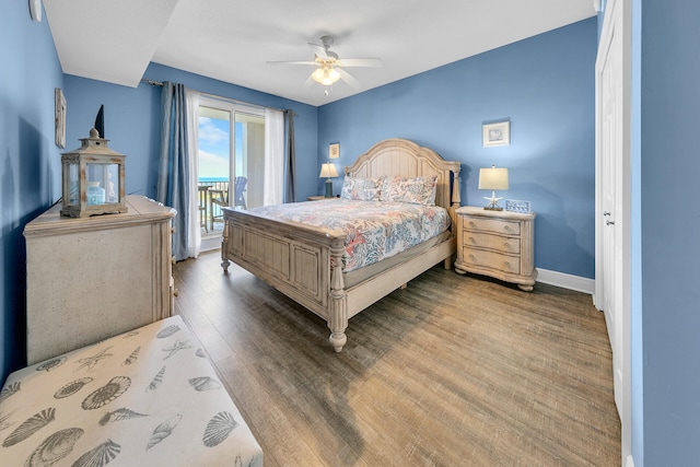 bedroom with access to outside, ceiling fan, baseboards, and wood finished floors