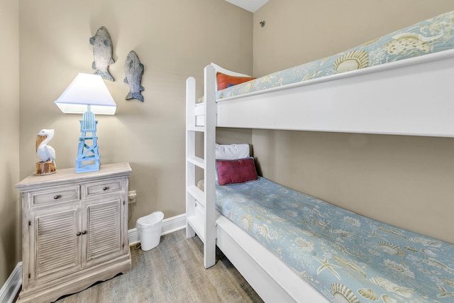 bedroom featuring baseboards and wood finished floors