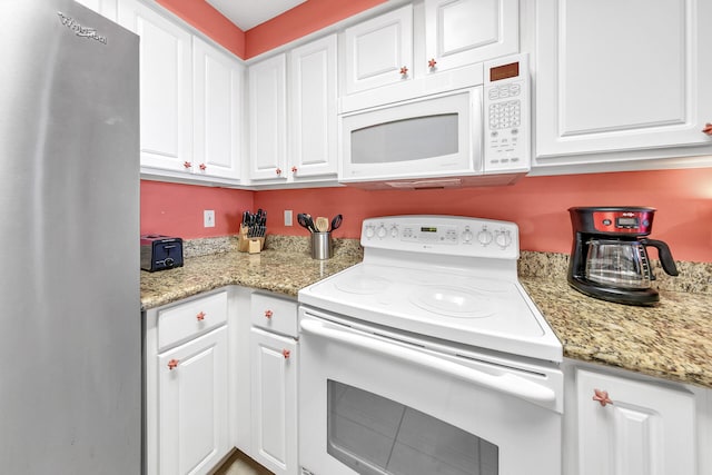 kitchen with white appliances and white cabinetry