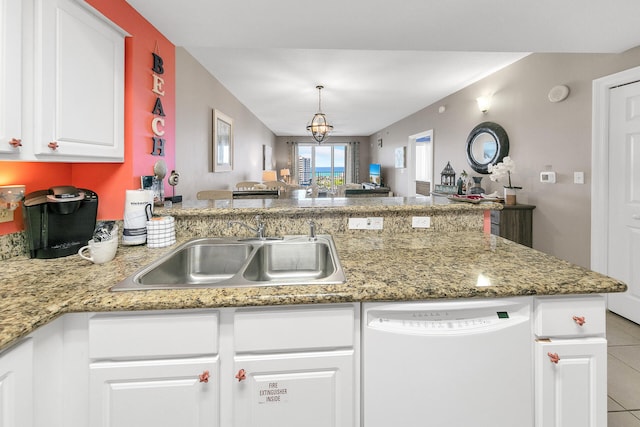 kitchen featuring a notable chandelier, white cabinetry, a sink, dishwasher, and a peninsula