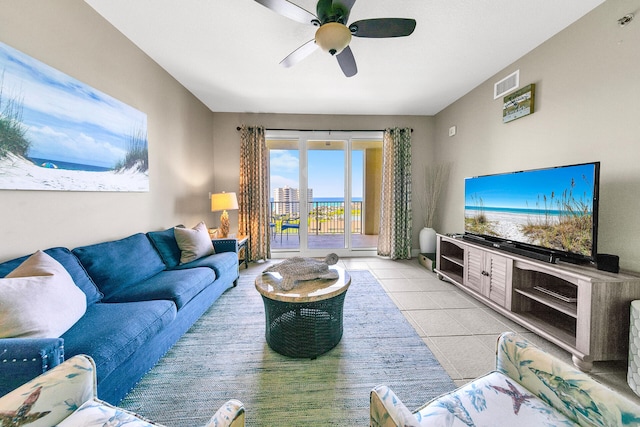 living room featuring light tile patterned floors, ceiling fan, and visible vents