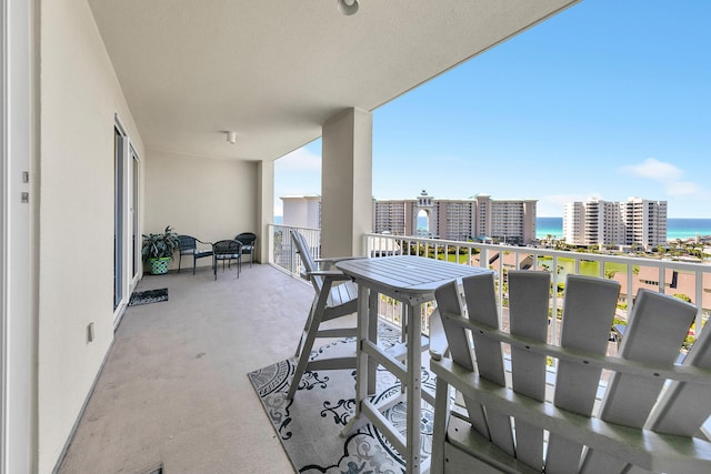 balcony with a water view and a city view