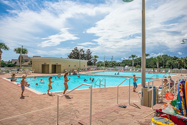 pool featuring a patio and fence