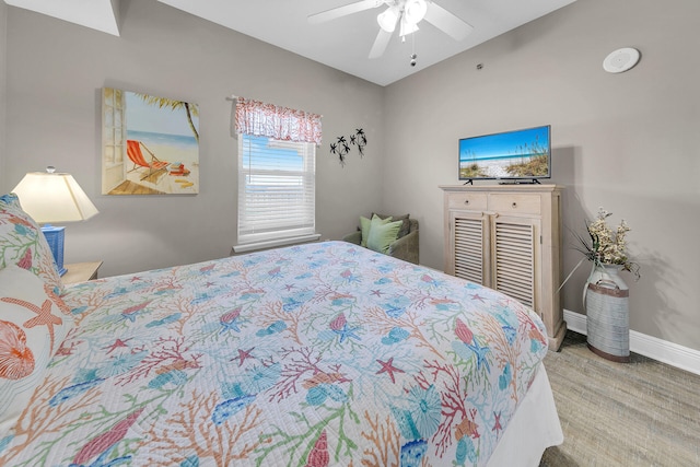 bedroom with ceiling fan, wood finished floors, and baseboards