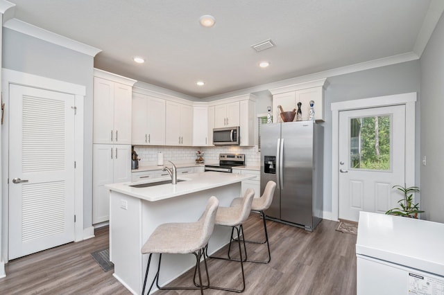 kitchen featuring white cabinetry, a kitchen island with sink, stainless steel appliances, and sink