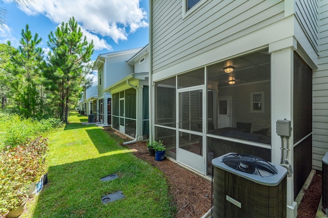 view of yard featuring cooling unit and a sunroom