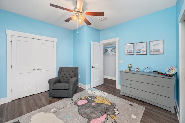 living area with ceiling fan and dark hardwood / wood-style floors