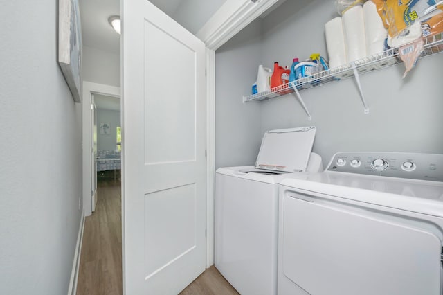 washroom featuring light hardwood / wood-style floors and washer and clothes dryer