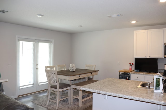 interior space with a wealth of natural light and dark hardwood / wood-style floors