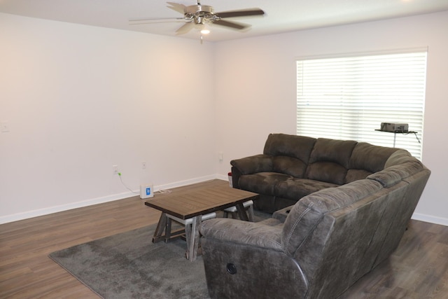 living room featuring ceiling fan and dark hardwood / wood-style flooring