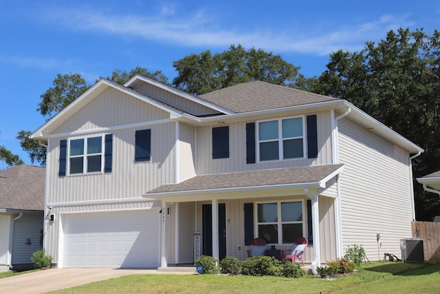 front facade with a garage, central AC, and a front yard