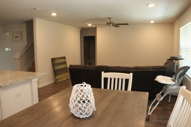 dining space featuring ceiling fan and dark hardwood / wood-style floors