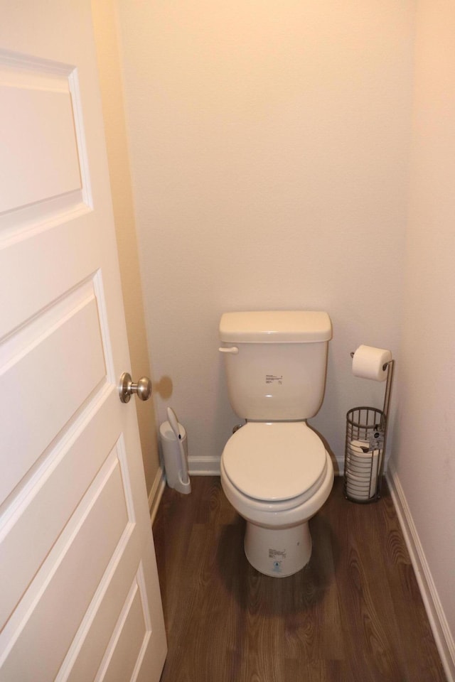 bathroom featuring hardwood / wood-style floors and toilet