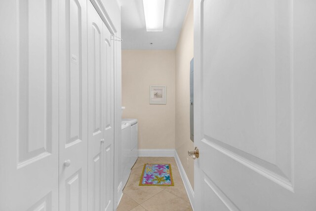 hall with light tile patterned flooring and washer and clothes dryer