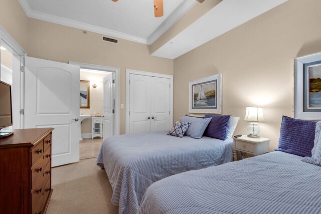 bedroom featuring light colored carpet, a closet, crown molding, and ceiling fan