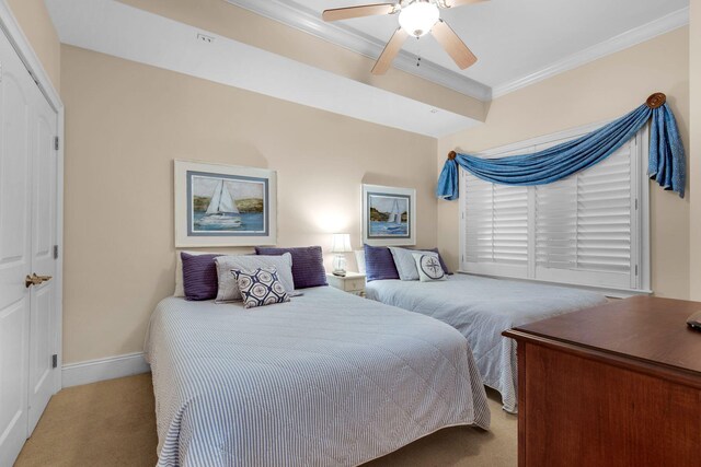 carpeted bedroom featuring a closet, ceiling fan, and ornamental molding