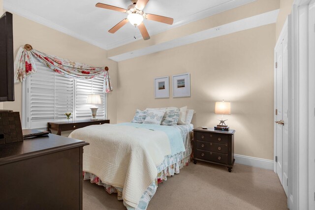 carpeted bedroom with ceiling fan and crown molding