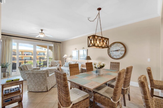 dining room with ceiling fan, crown molding, and light tile patterned floors