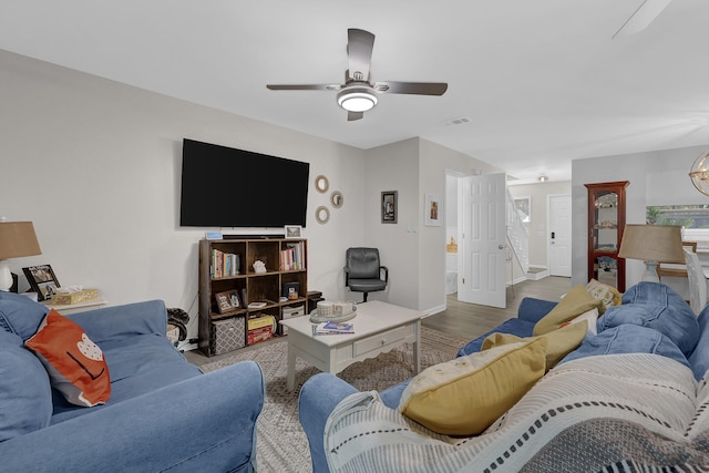 living room featuring ceiling fan and light hardwood / wood-style floors