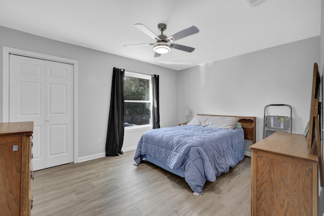 bedroom featuring light wood-type flooring, a closet, and ceiling fan