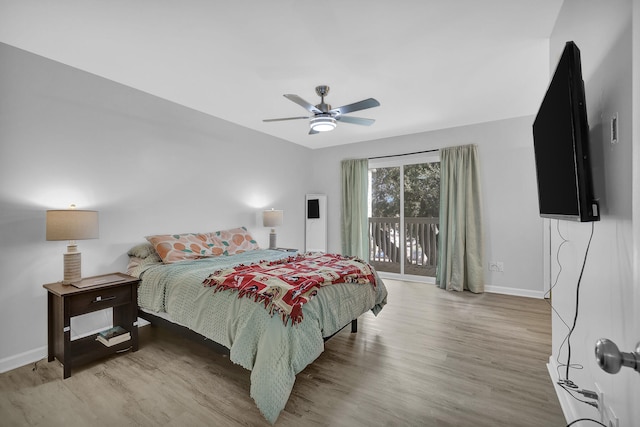 bedroom with access to exterior, ceiling fan, and hardwood / wood-style flooring