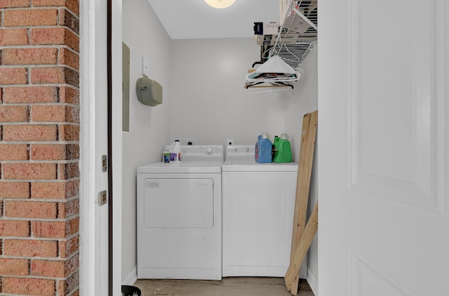 laundry area with light wood-type flooring and separate washer and dryer