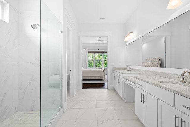 bathroom featuring tiled shower, tile patterned flooring, vanity, ceiling fan, and toilet