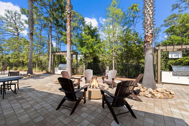 view of patio featuring area for grilling, grilling area, and an outdoor fire pit