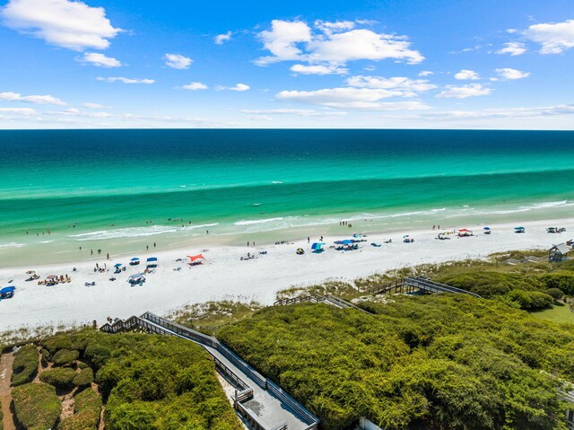 birds eye view of property with a beach view and a water view