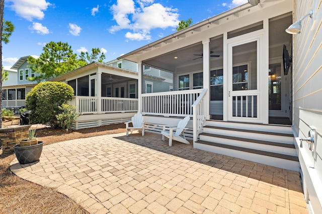 exterior space featuring a sunroom and ceiling fan