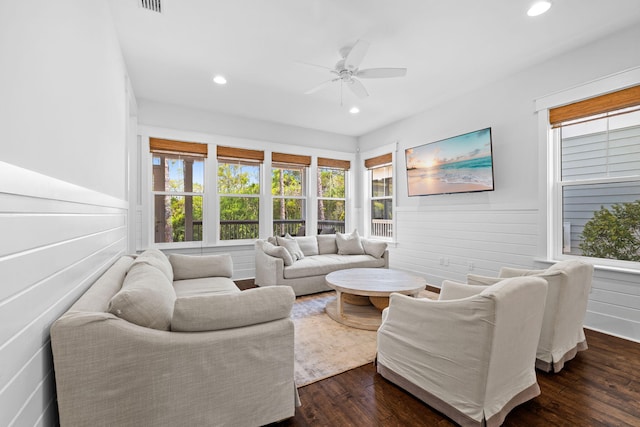 living room featuring ceiling fan and dark hardwood / wood-style floors