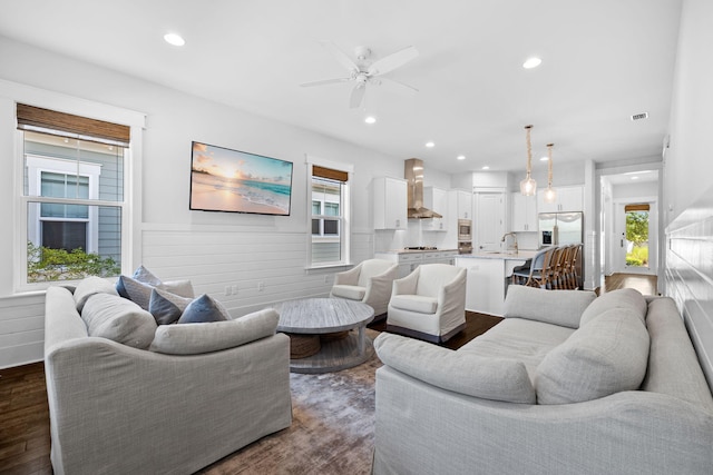 living room with sink, ceiling fan, and dark hardwood / wood-style floors