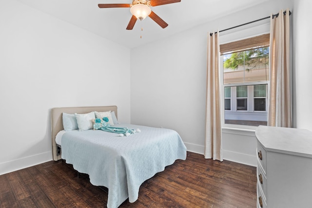 bedroom with ceiling fan and dark hardwood / wood-style floors