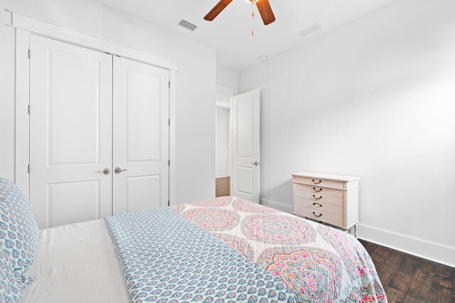 bedroom with dark hardwood / wood-style flooring, a closet, and ceiling fan