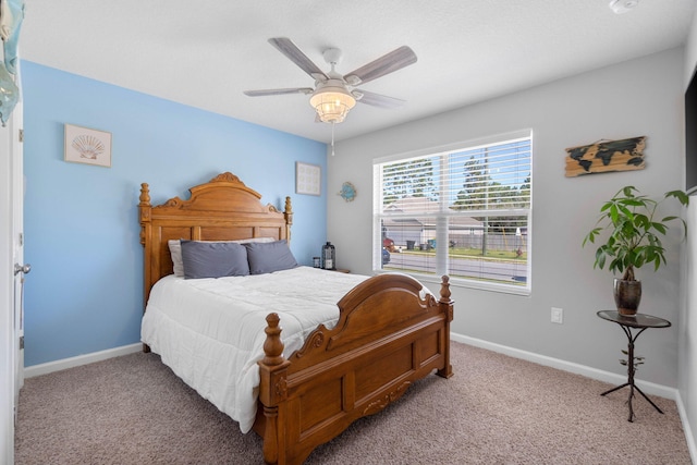 bedroom featuring ceiling fan and light carpet