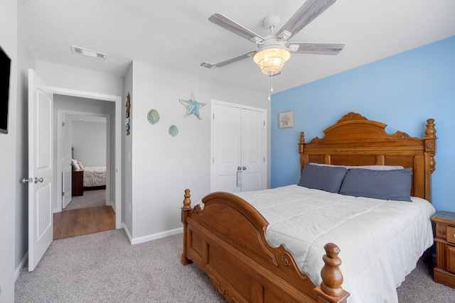 bedroom with light colored carpet, a closet, and ceiling fan