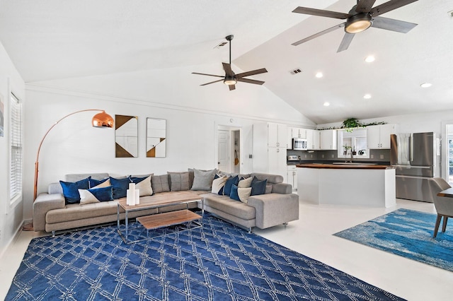 living room featuring ceiling fan, dark carpet, sink, and high vaulted ceiling